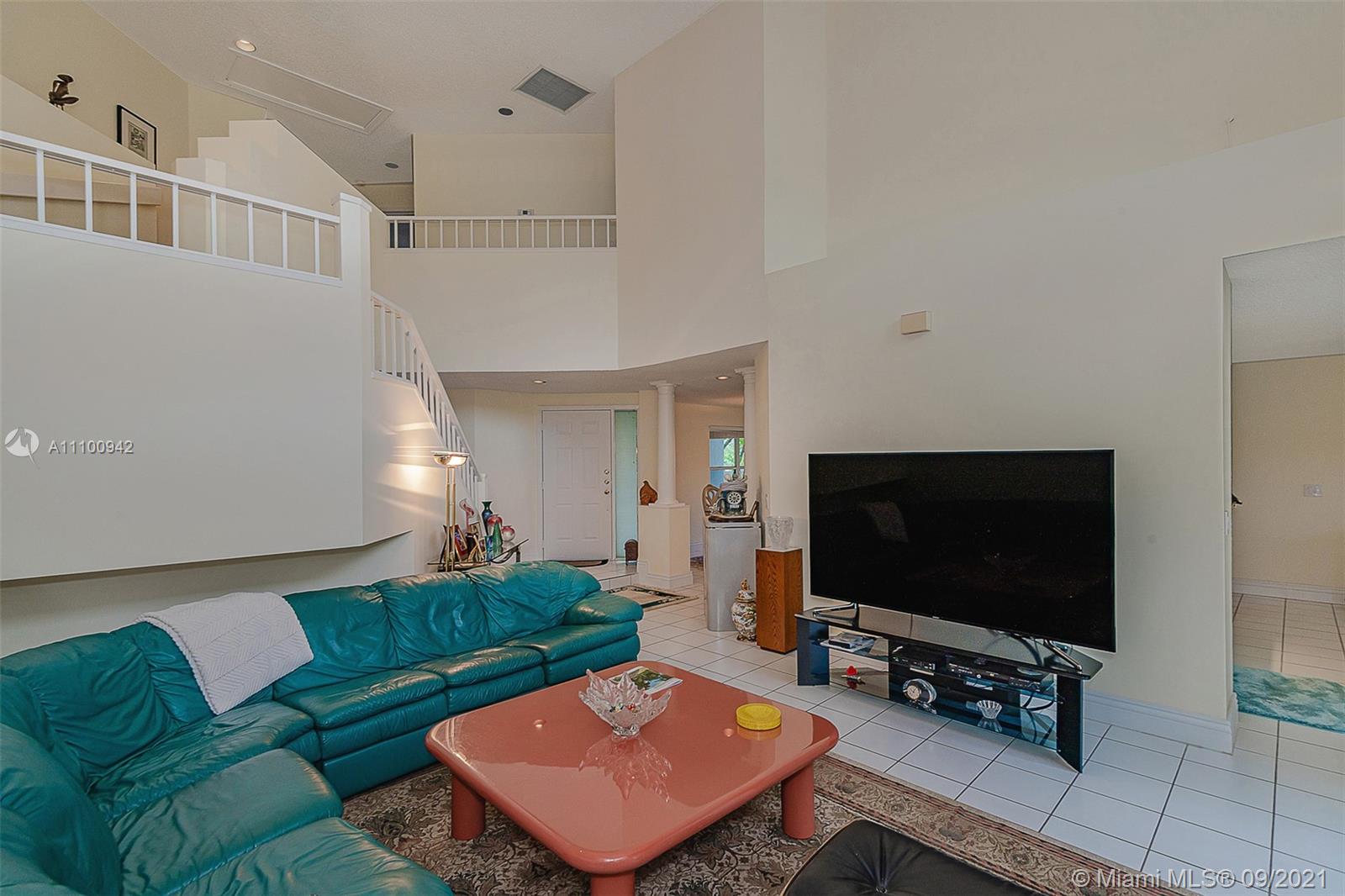 2295 Northwest 53rd Street Boca Raton, FL 33496 - Photo 6 of 25 a living room with furniture and a flat screen tv