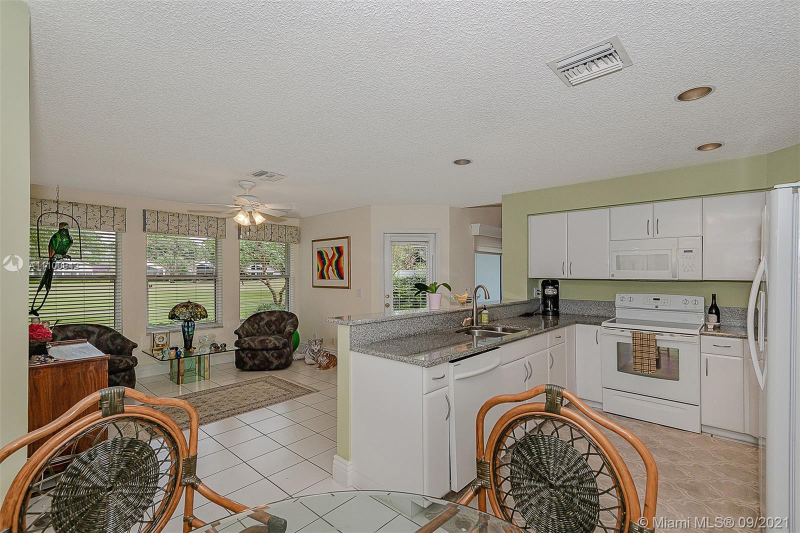 2295 Northwest 53rd Street Boca Raton, FL 33496 - Photo 8 of 25 a view of a kitchen with sink washer and dryer