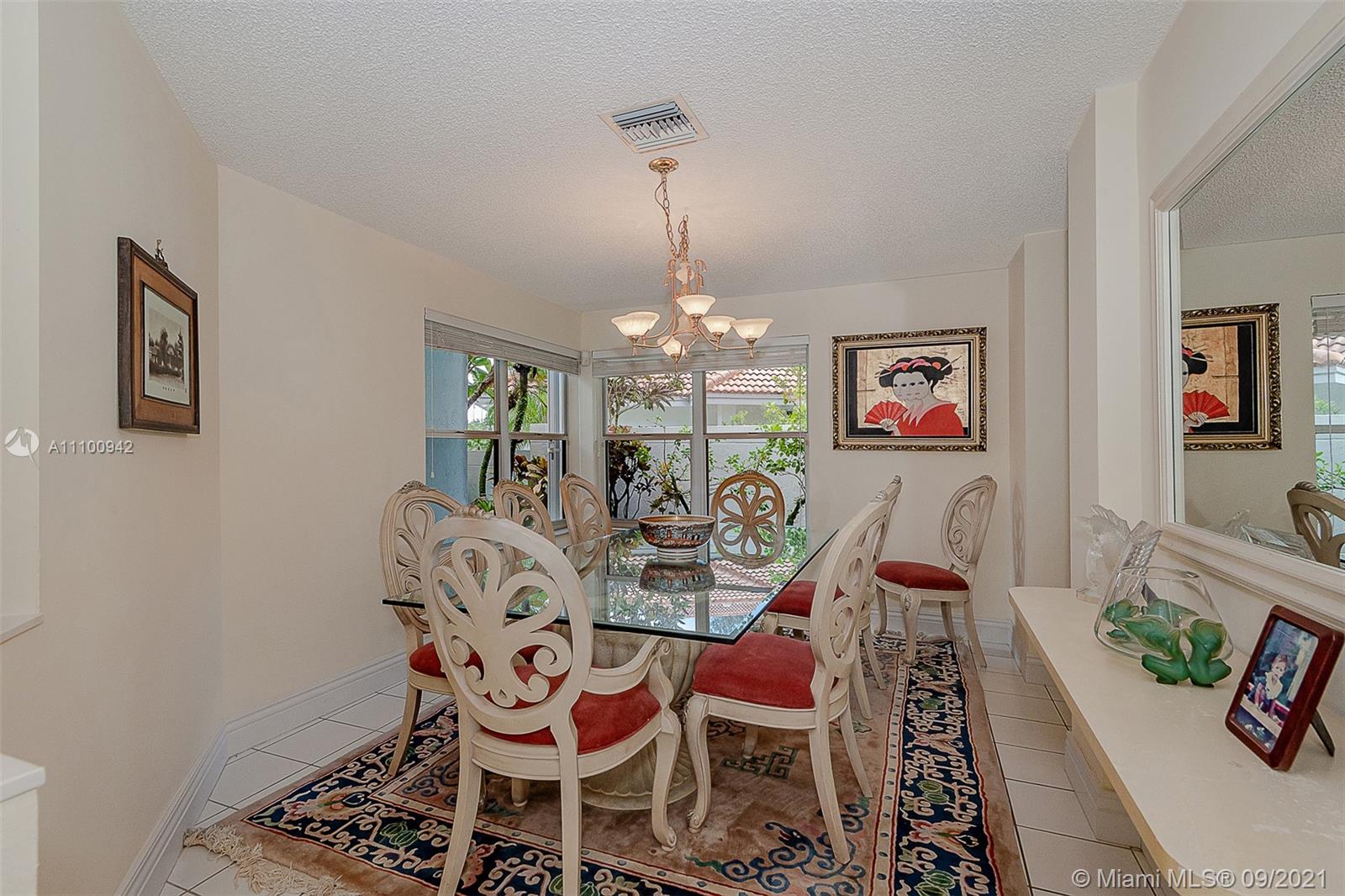 2295 Northwest 53rd Street Boca Raton, FL 33496 - Photo 10 of 25 a view of a dining room with furniture and chandelier