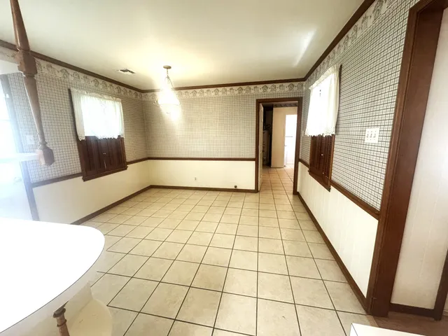 an empty room with windows and closet