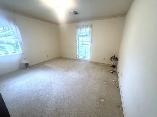 a bed sitting in a bedroom next to a window