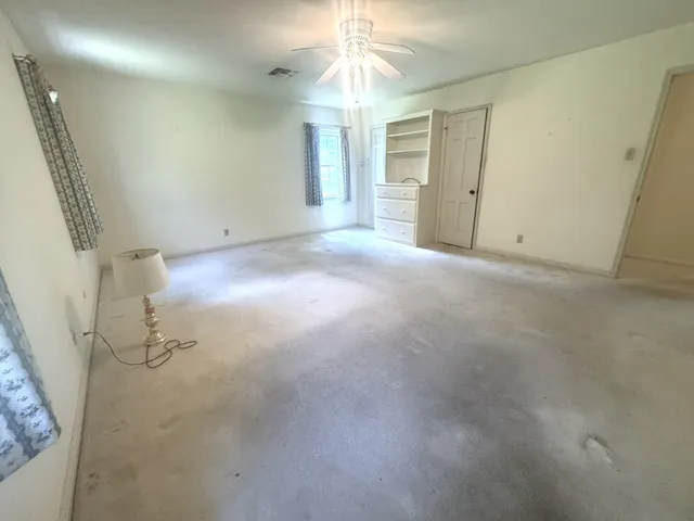 a bathroom with a granite countertop toilet sink and mirror