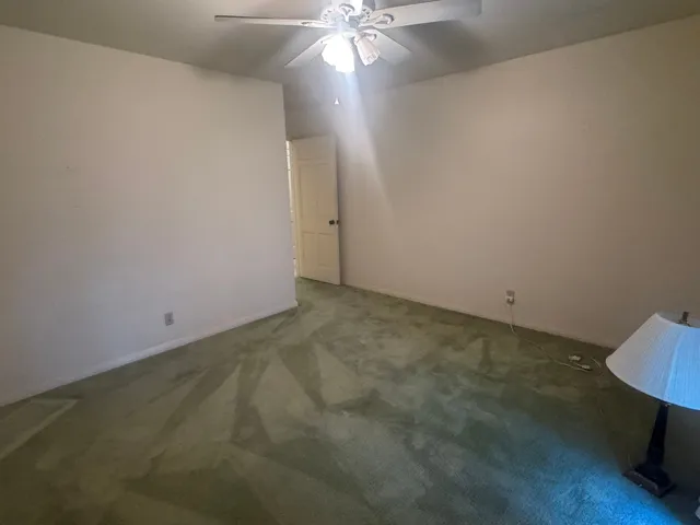 a bedroom with a bed and a mirror on the dresser