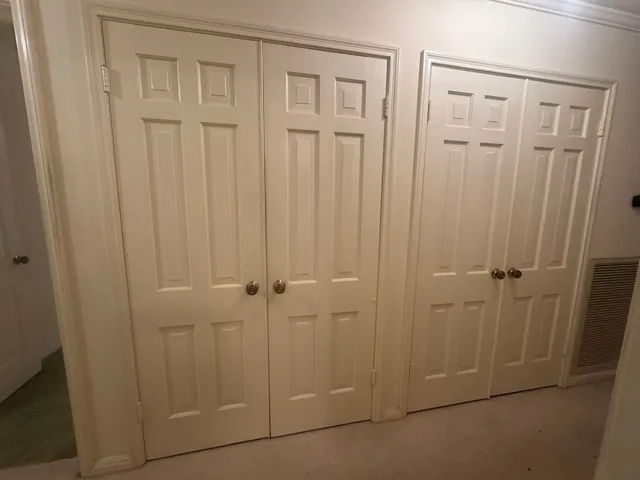 a view of walk in closet with empty racks