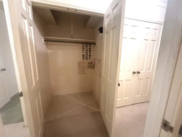 a front view of house with yard and trees in the background