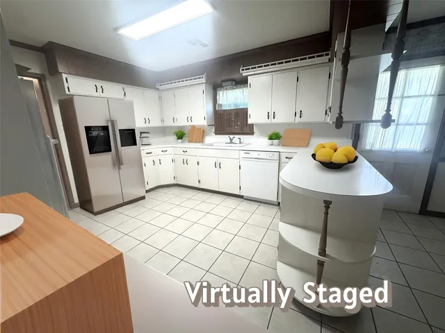 a kitchen with stainless steel appliances a stove a sink and a refrigerator
