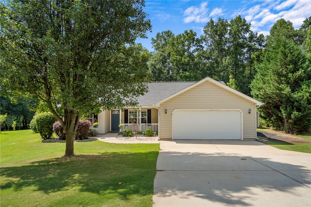 167 Mediterranean Avenue Anderson, SC 29621 - Photo 1 of 33 A welcoming facade with a covered porch, a neat lawn, and a wide driveway offers charming curb appeal.