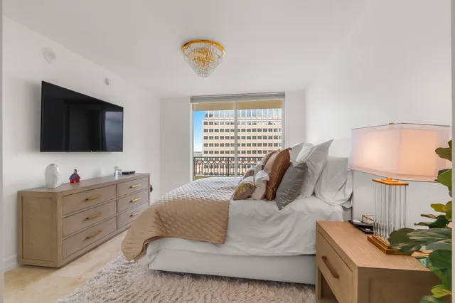 a bedroom with a bed and flat screen tv