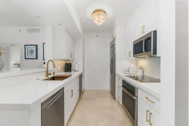 a kitchen with a sink stove and microwave