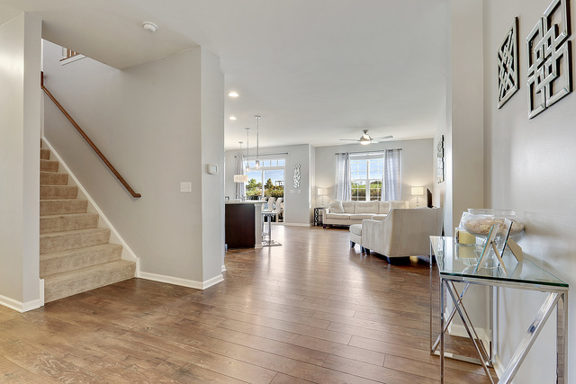2816 Church Road Aurora, IL 60502 - Photo 5 of 20 a view of a living room and kitchen with furniture wooden floor and a kitchen