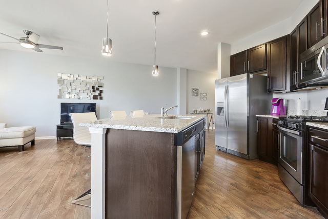 2816 Church Road Aurora, IL 60502 - Photo 8 of 20 a kitchen with stainless steel appliances granite countertop a refrigerator a stove and a wooden floors