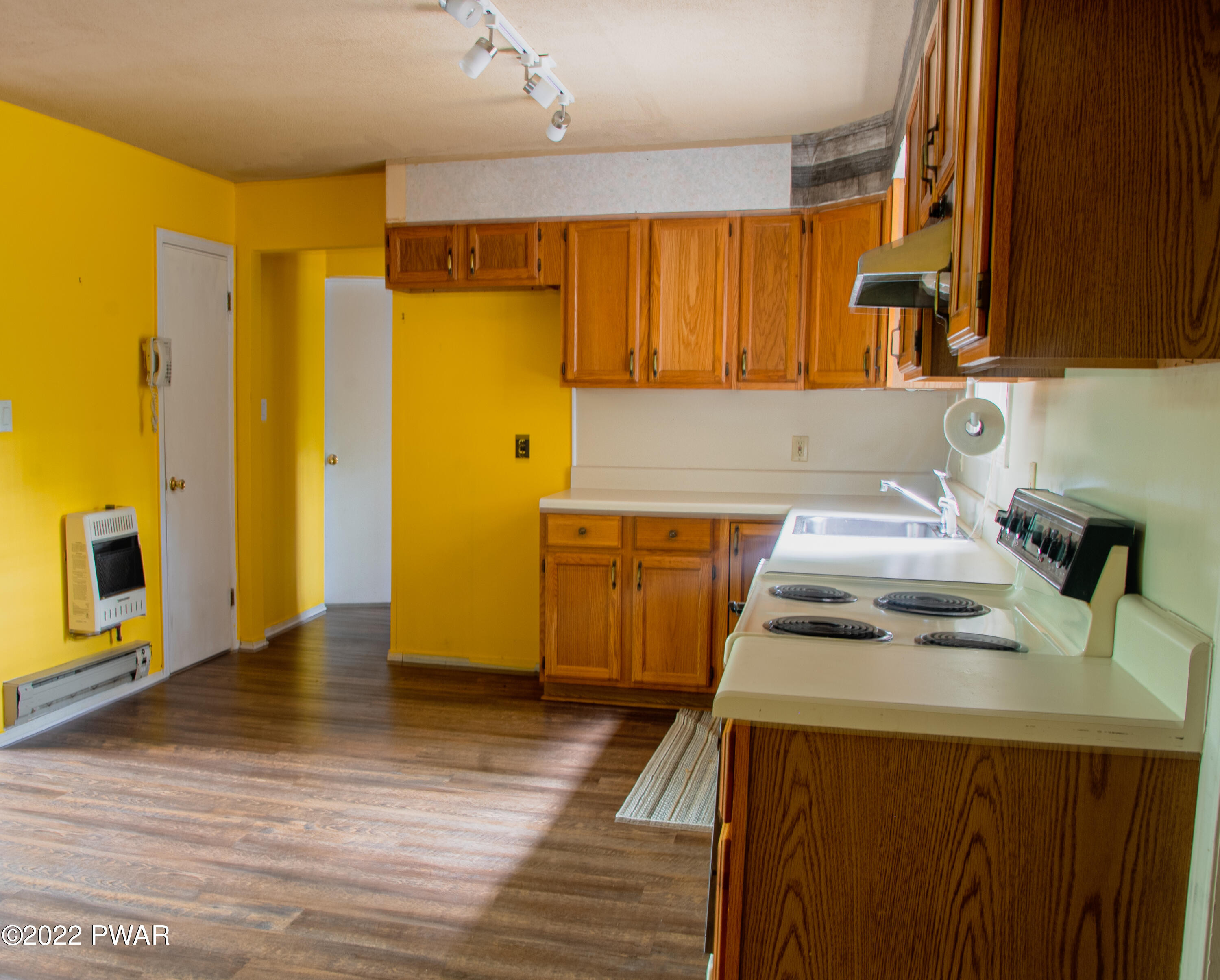 375 Mallard Lane Bushkill, PA 18324 - Photo 9 of 28 a kitchen with a sink a stove wooden floor and cabinets