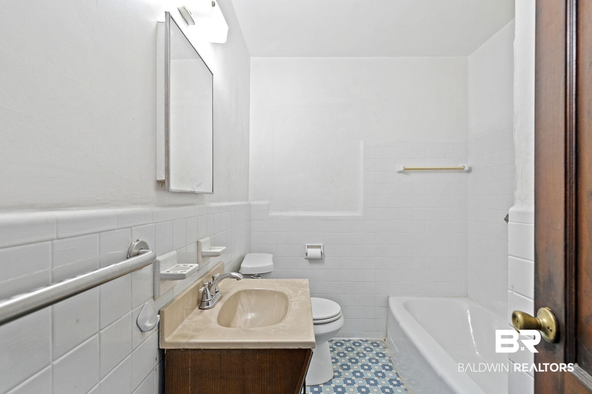 1665 Johnston Street Mobile, AL 36605 - Photo 11 of 17 Bathroom featuring vanity, tile patterned floors, toilet, tile walls, and a tub