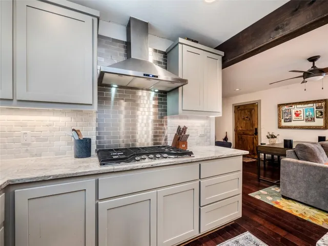a kitchen with stainless steel appliances granite countertop a sink stove and cabinets