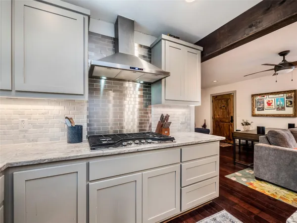 a kitchen with stainless steel appliances granite countertop a sink stove and cabinets