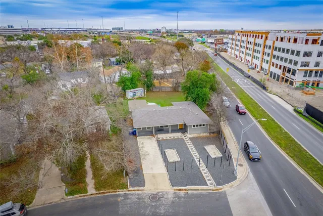 an aerial view of residential houses with outdoor space and street view
