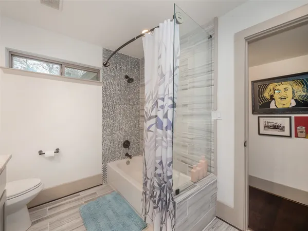 a bathroom with a bathtub a toilet and a shower