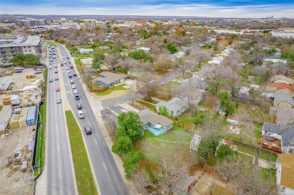 an aerial view of residential houses with outdoor space