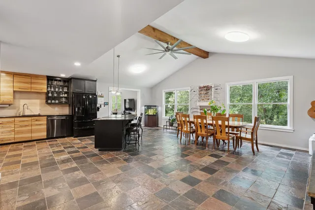 a view of a house with backyard and sitting area
