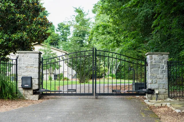 a kitchen with stainless steel appliances kitchen island granite countertop dining table chairs and a refrigerator