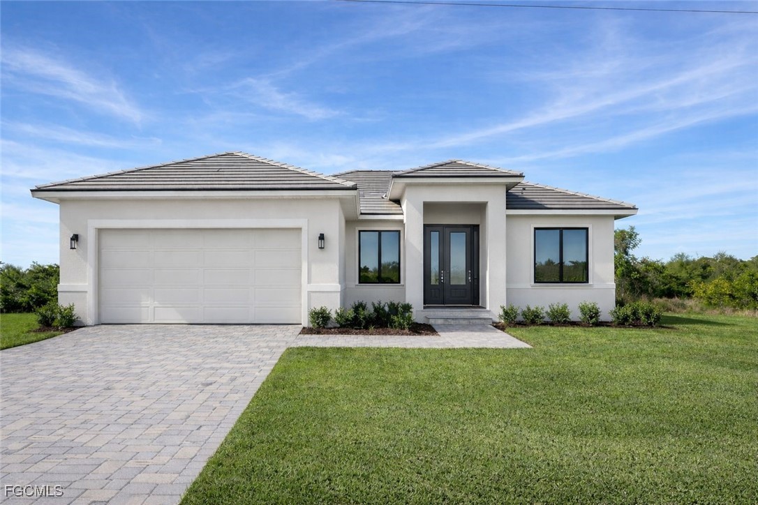 3903 11th Street Southwest Lehigh Acres, FL 33976 - Photo 1 of 12 a front view of a house with a yard and garage
