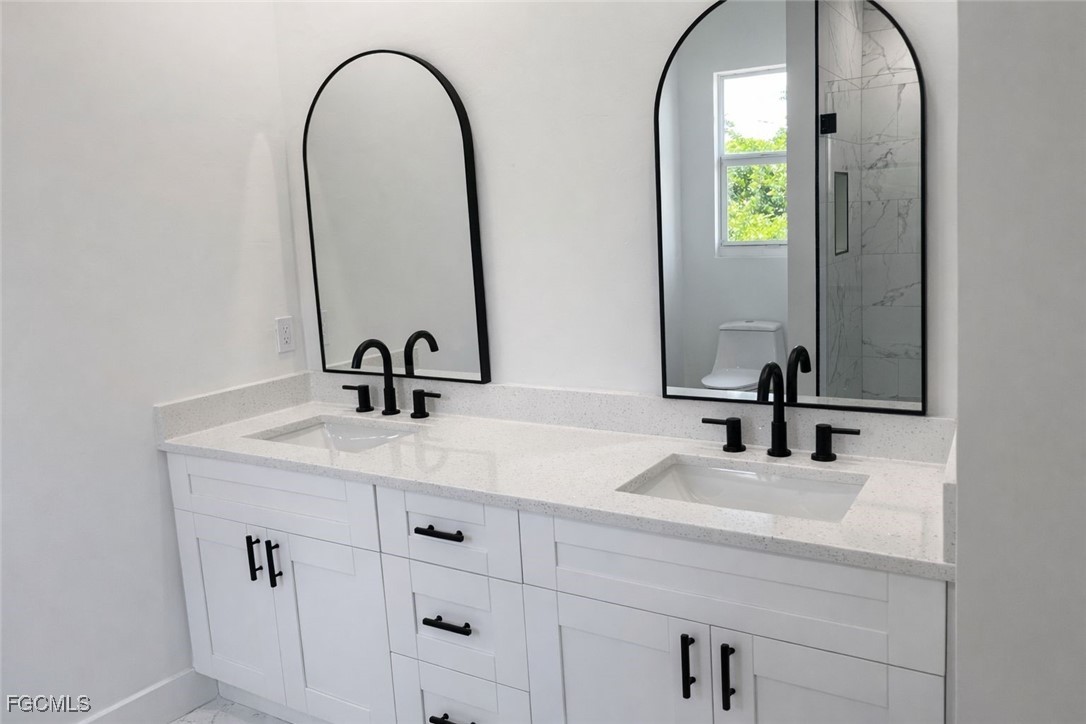 3903 11th Street Southwest Lehigh Acres, FL 33976 - Photo 10 of 12 a bathroom with a sink and a mirror