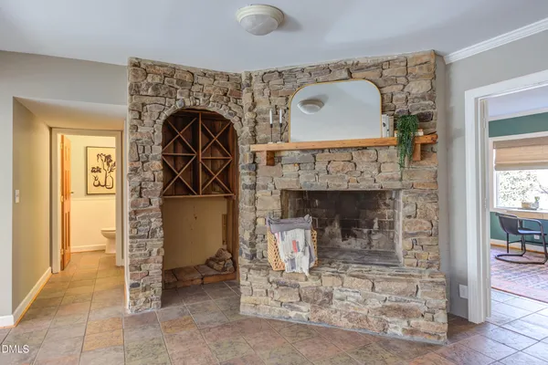 a bathroom with a granite countertop sink a mirror a bathtub and next to a window