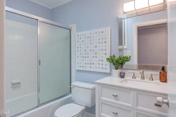 a bathroom with a sink a mirror and a shower curtain