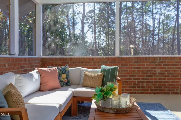 a view of a yard with plants and trees
