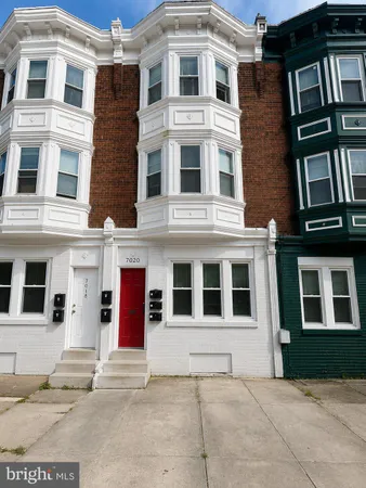 a building with a window and a car parked in front of it