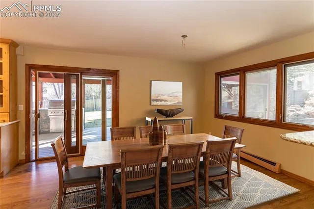 a view of a dining room with furniture a chandelier and wooden floor