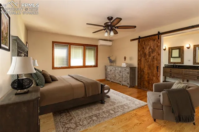 a bedroom with a bed a couch and dresser