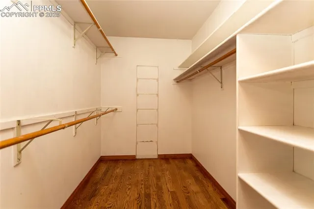 a view of walk in closet with empty racks