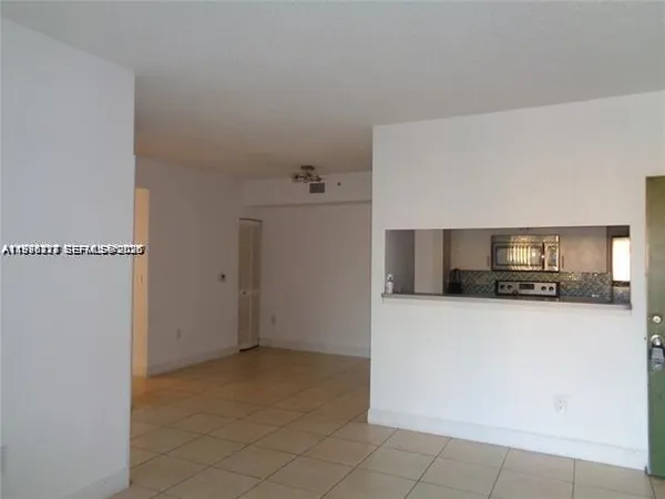 a kitchen with granite countertop a stove and a microwave