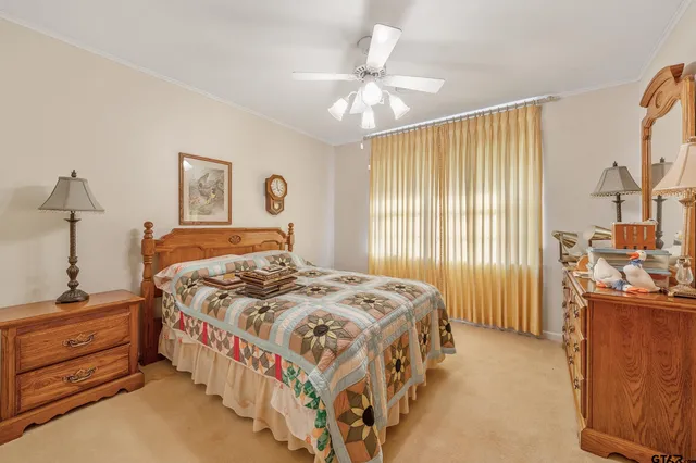 a bedroom with a bed and a dresser