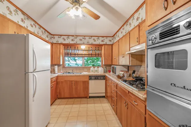 a kitchen with a window a sink and cabinets