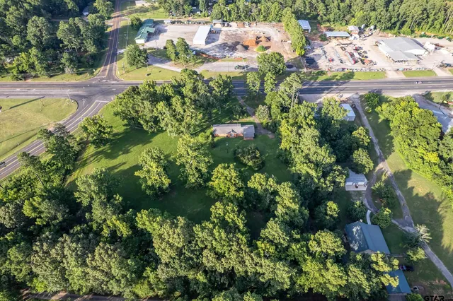 an aerial view of a house with a yard and garden