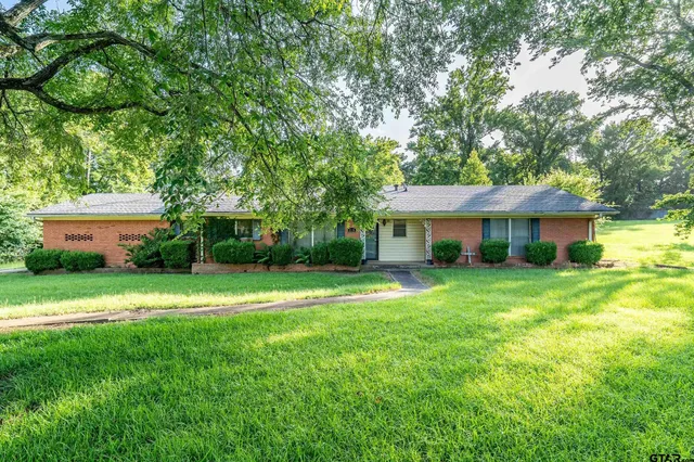 a house view with a sitting space and garden