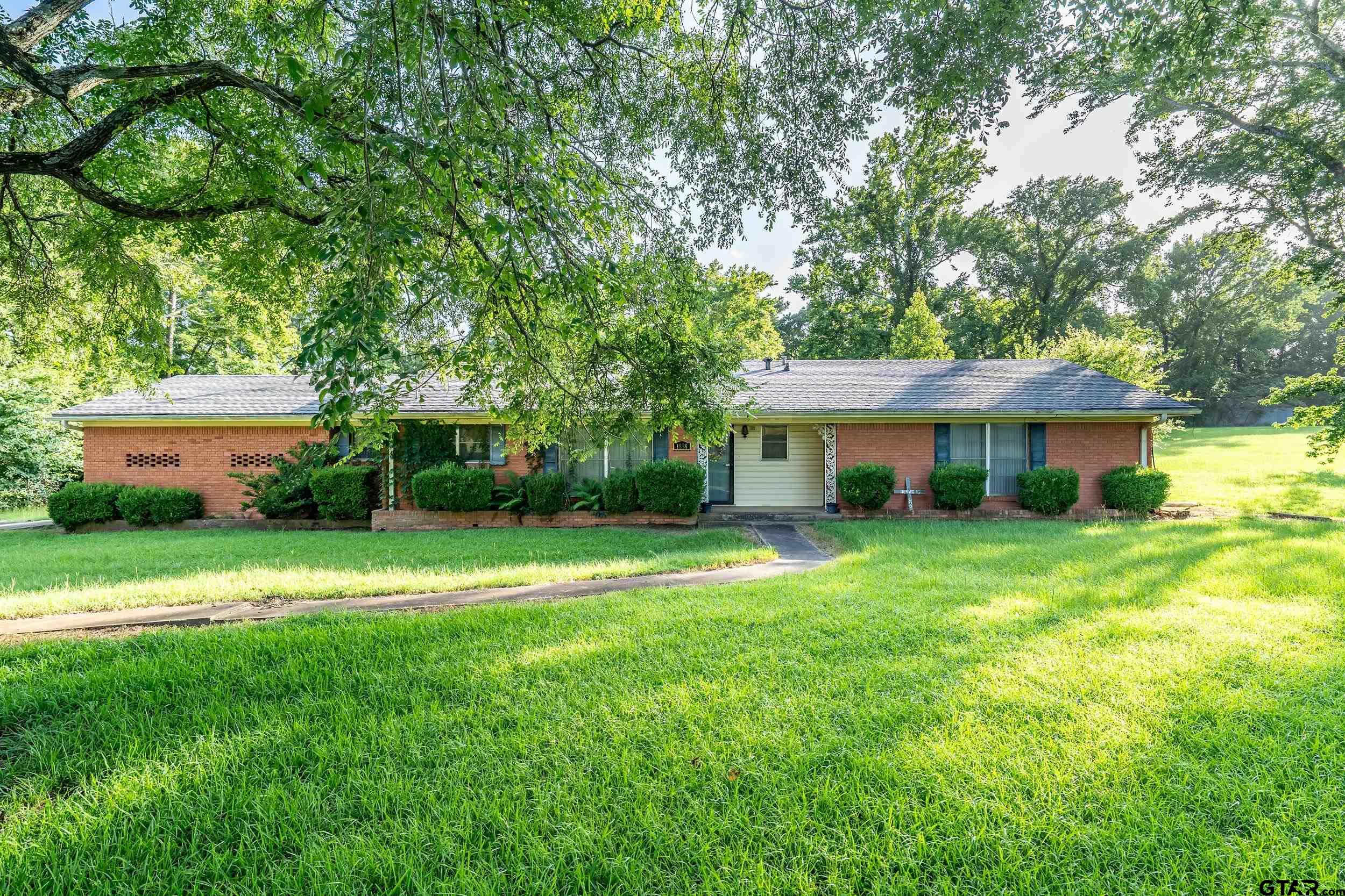 1858 Dickinson Drive Rusk, TX 75785 - Photo 5 of 35 a front view of a house with a yard and trees