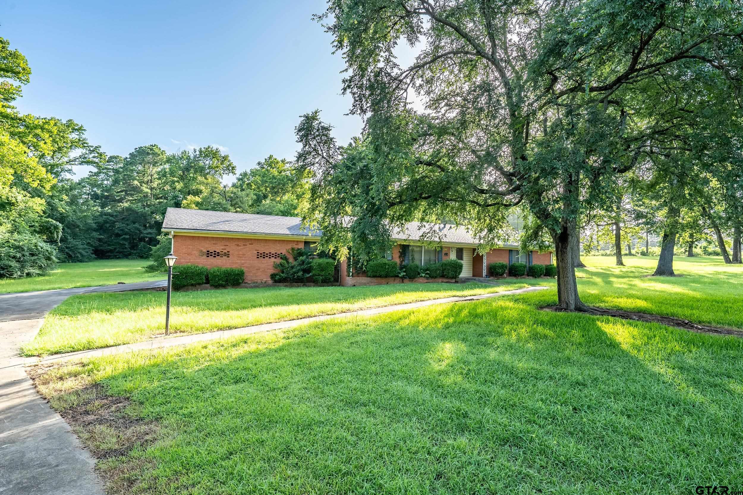 1858 Dickinson Drive Rusk, TX 75785 - Photo 6 of 35 a house view with a sitting space and garden