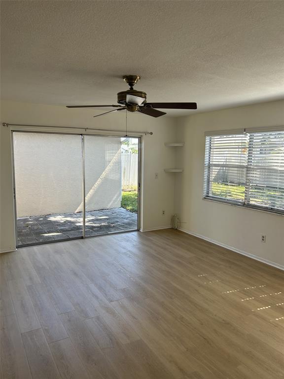 8873 Tami Street Seminole, FL 33772 - Photo 13 of 26 an empty room with wooden floor and windows