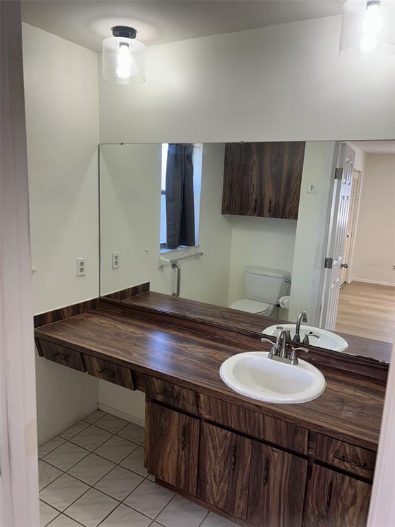 8873 Tami Street Seminole, FL 33772 - Photo 17 of 26 a bathroom with a sink a mirror and vanity
