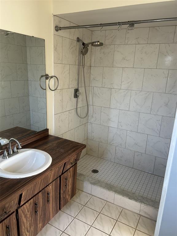 8873 Tami Street Seminole, FL 33772 - Photo 18 of 26 a bathroom with a sink shower and a mirror