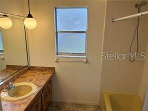 8873 Tami Street Seminole, FL 33772 - Photo 20 of 26 a bathroom with a sink and a mirror