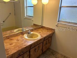 8873 Tami Street Seminole, FL 33772 - Photo 21 of 26 a bathroom with a sink and a mirror