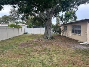 8873 Tami Street Seminole, FL 33772 - Photo 25 of 26 a view of a backyard with a tree