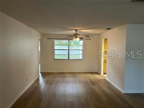 8873 Tami Street Seminole, FL 33772 - Photo 6 of 26 an empty room with wooden floor and windows