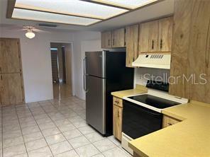 8873 Tami Street Seminole, FL 33772 - Photo 9 of 26 a kitchen with stainless steel appliances granite countertop a refrigerator and a sink