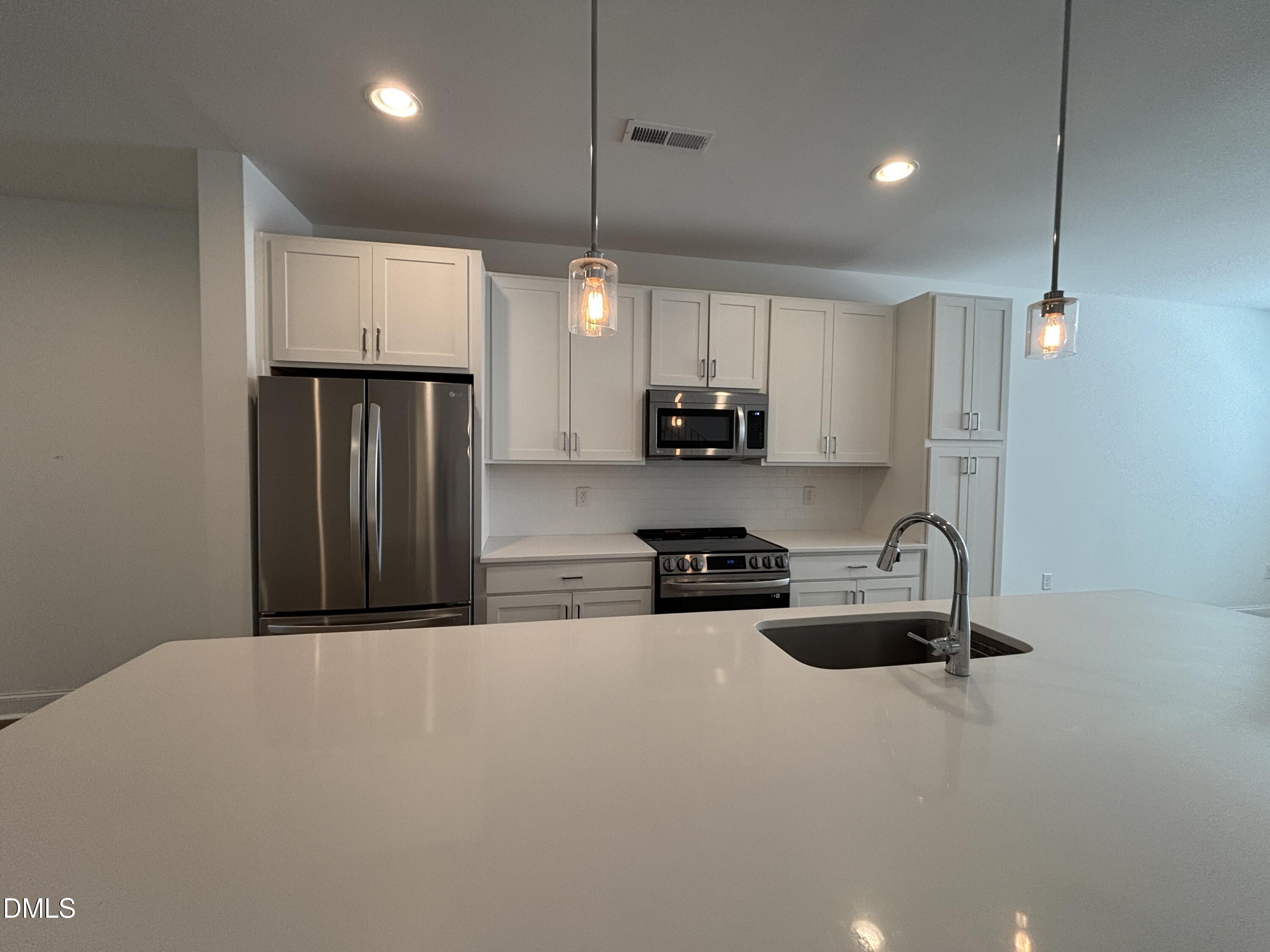 5710 Parker Pnes Court Raleigh, NC 27609 - Photo 37 of 78 a kitchen with stainless steel appliances a refrigerator sink and microwave