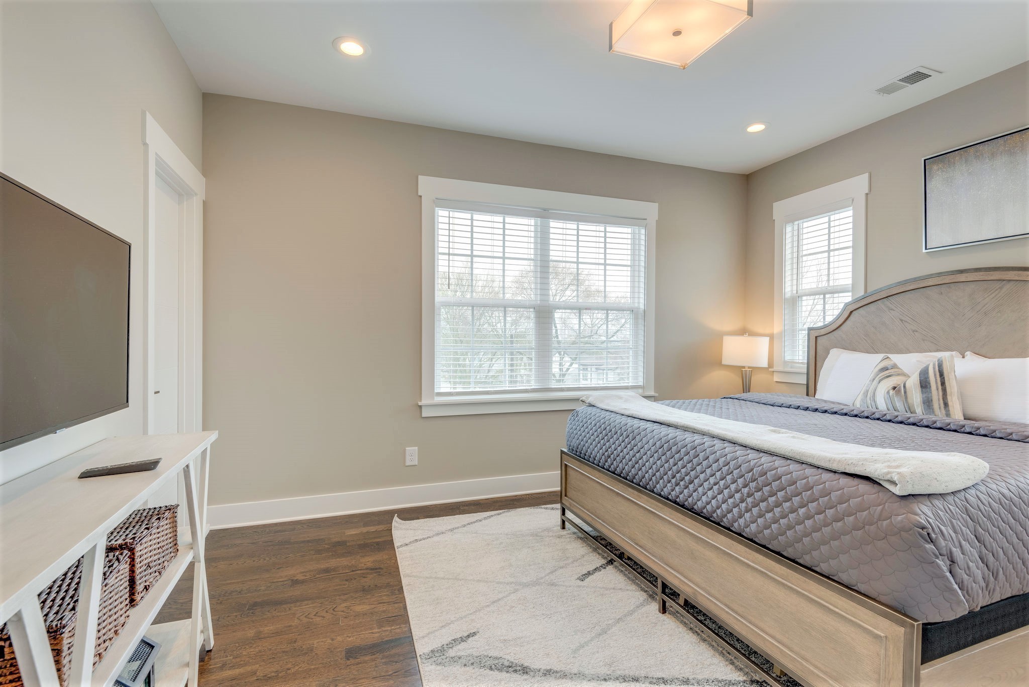 601 Ries Avenue Nashville, TN 37209 - Photo 10 of 34 a spacious bedroom with a bed and a flat screen tv